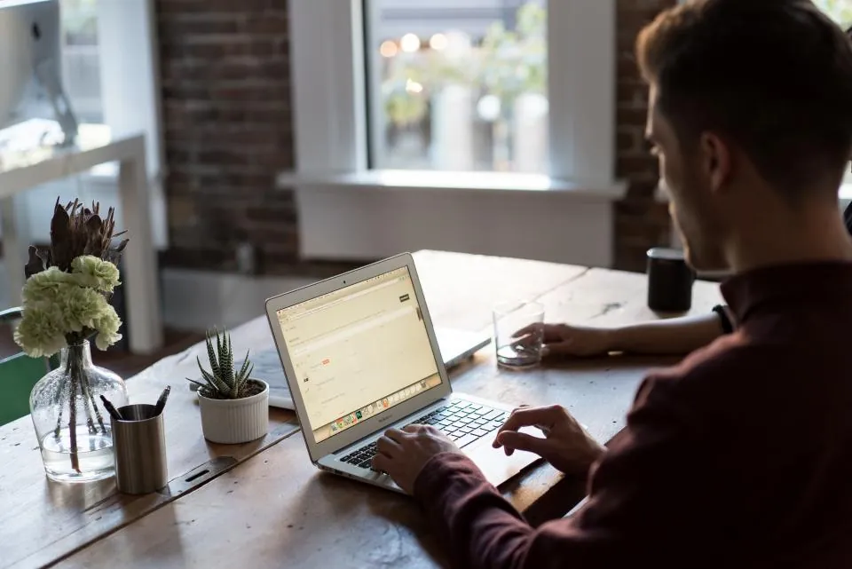 A man working on a laptop at home